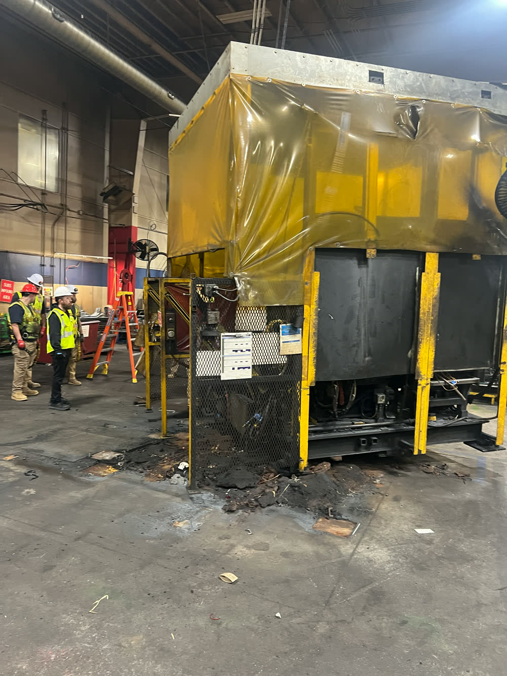 Guarded robot cell with weld curtains on a production floor